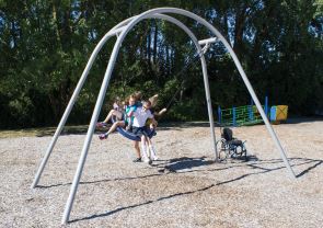 Children playing on playground swing Children playing on playground swing